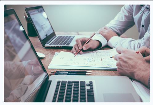 Two people working together to solve a problem