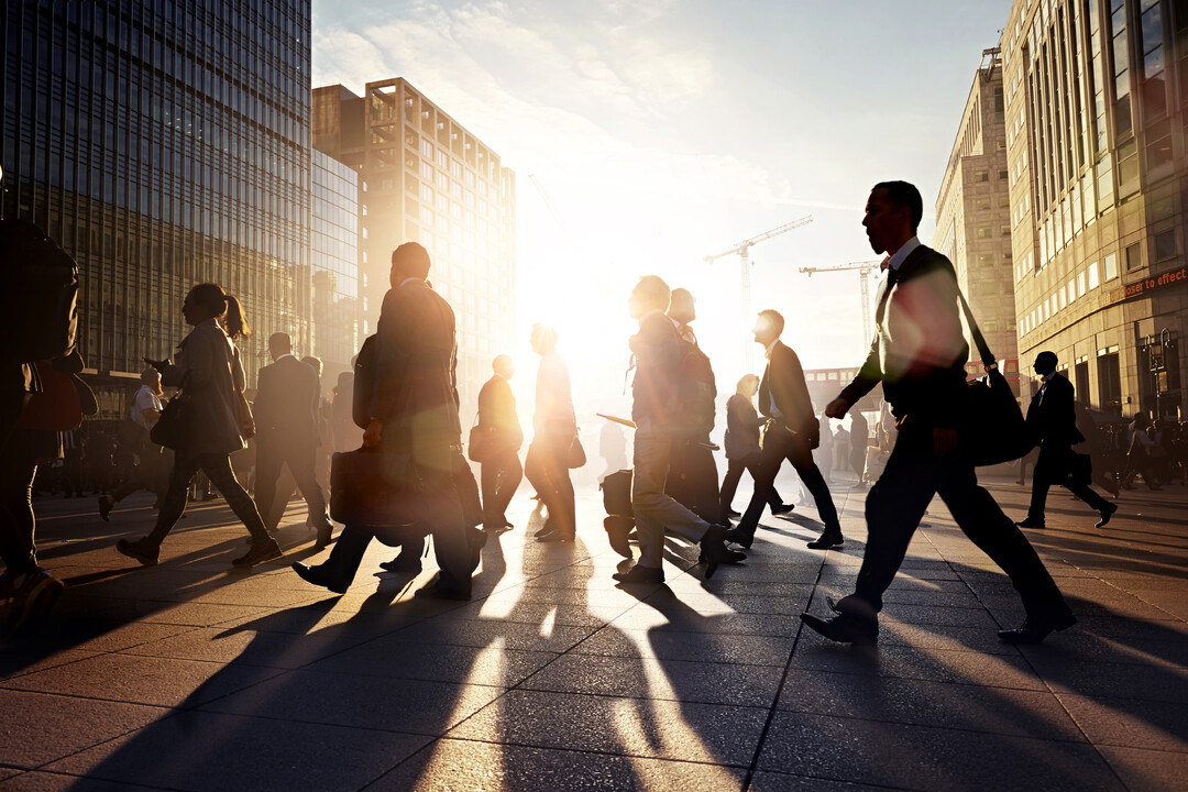 Large group of people heading to work at sunrise